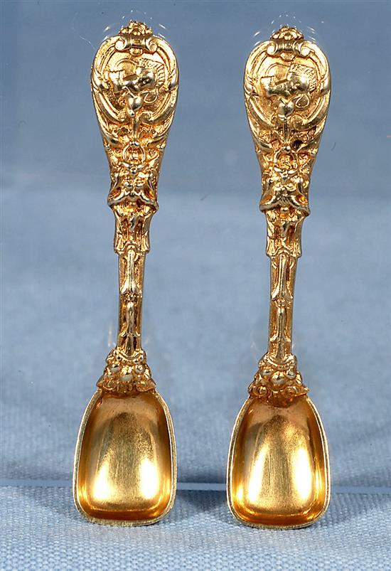 A good pair of Victorian cast silver gilt salt cellars and spoons, by Jane Brownett? height 40mm, weight 7.3 oz/230grms.